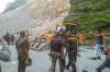 Army personnel at the site where a boulder rolled down and